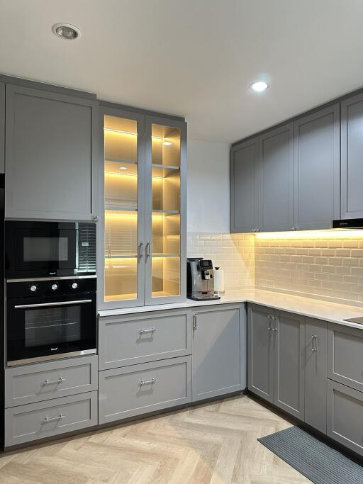 Modern kitchen with gray cabinetry and built-in appliances