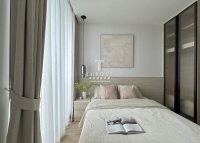 Modern bedroom with neutral tones and a cozy bed