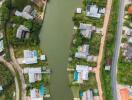 Aerial view of a neighborhood with houses and a lake