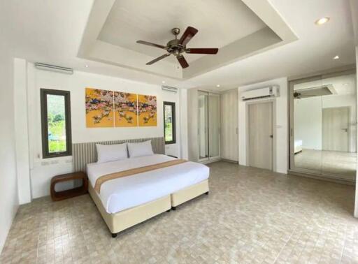 Spacious bedroom with modern decor and ceiling fan