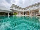 Outdoor view of the pool area with building in the background