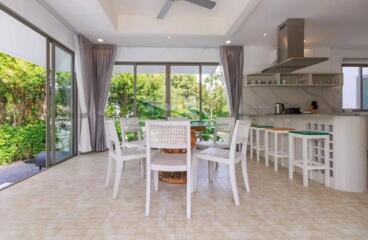 Modern open kitchen with dining area and large windows