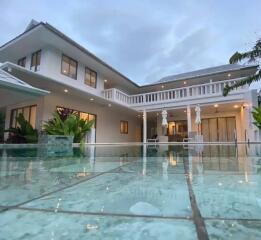 Exterior view of a modern two-story house with a pool