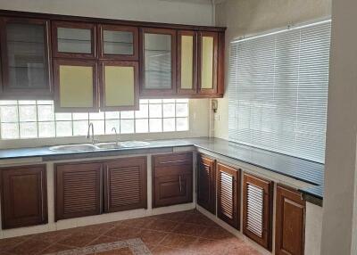 Modern kitchen with wooden cabinets and large window