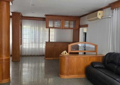 Spacious living room with wooden accents and furniture