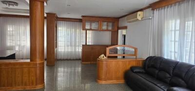 Spacious living room with wooden accents and furniture