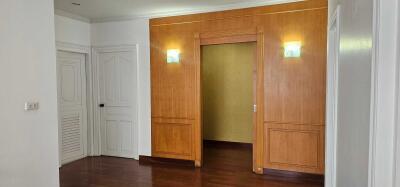 Interior view of a room with white walls and wooden door