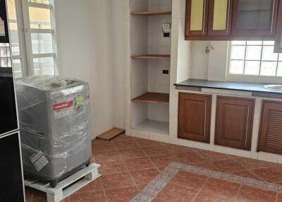 Spacious kitchen with appliances and wooden cabinetry