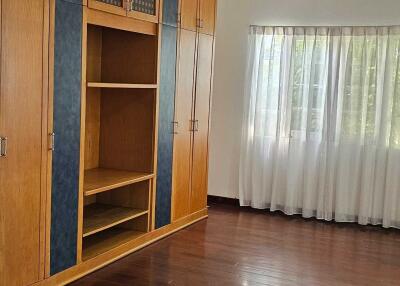 Spacious bedroom with cabinets and large window