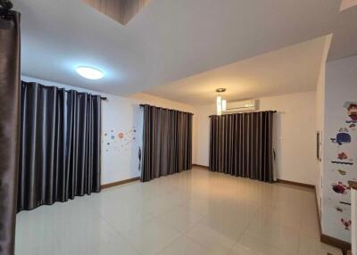 Bedroom with curtains, tile flooring, ceiling light, and wall decals