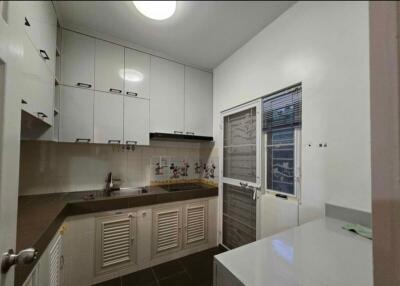 Modern kitchen with white cabinetry and appliances