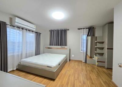 Spacious bedroom with wooden flooring