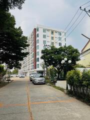 Exterior view of a multi-story residential building with a driveway