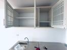 Kitchen with open cabinets, sink, and counter space