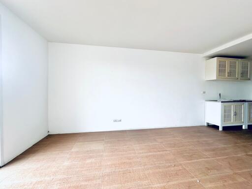 Spacious living area with tile flooring and a kitchenette