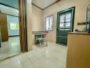 Simple kitchen with wooden chair and tiled floor