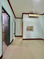 Interior view of a room with an adjacent bathroom and air conditioning