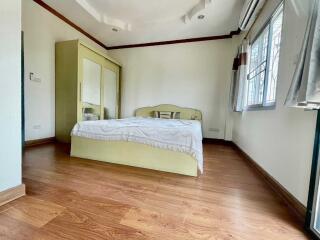 Bedroom with wooden flooring and large windows