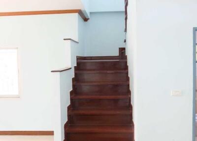 Indoor wooden staircase with light blue walls