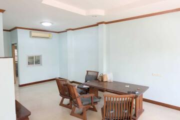 Open dining area with wooden furniture and air conditioning