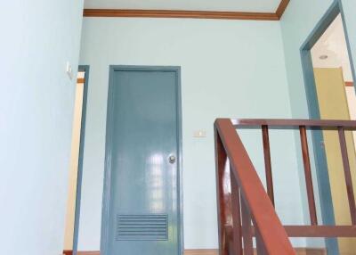 Staircase leading to a hallway with doors