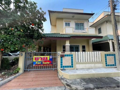 Exterior view of a house with a for sale sign