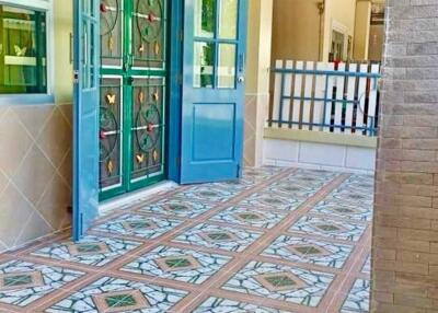 Main entrance with decorative iron doors and tiled flooring