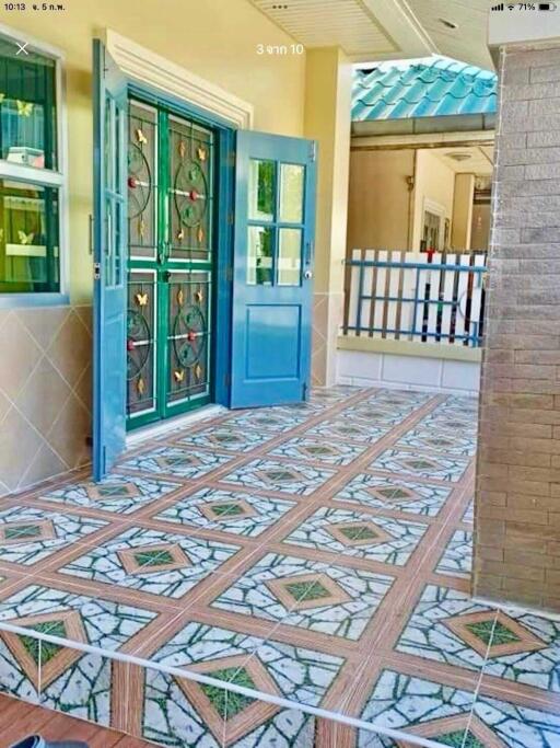 Main entrance with decorative iron doors and tiled flooring