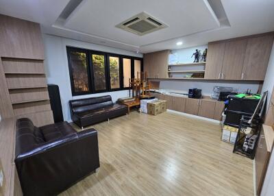 Spacious living room with modern furnishings and ample storage