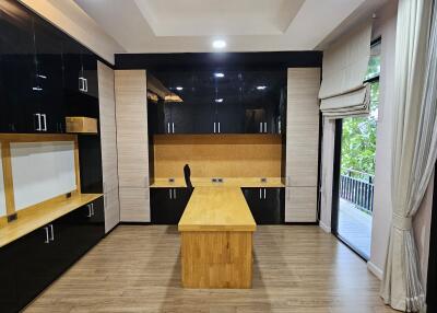 Modern home office with wooden flooring and built-in cabinetry