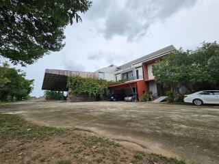 Modern house with a large driveway and green surroundings