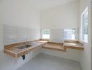 Minimalist kitchen with wooden countertops and white tiles