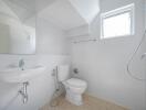 Bright bathroom with white fixtures and a small window