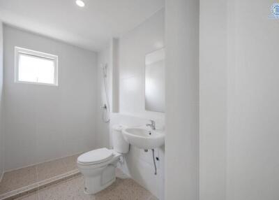 minimalistic white bathroom with a window, shower, toilet, and sink