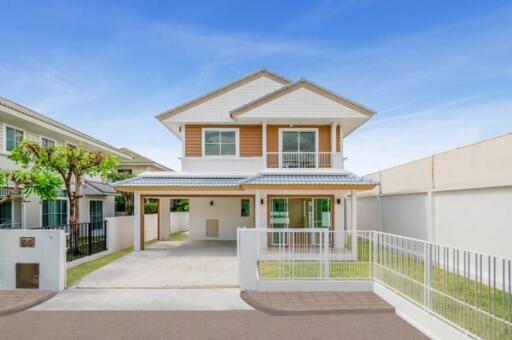 Modern two-story house with a driveway and small lawn