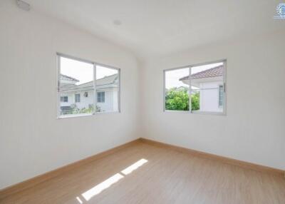 Bright and empty bedroom with large windows