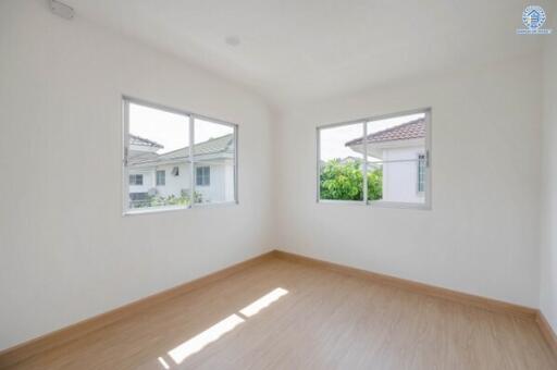 Bright and empty bedroom with large windows