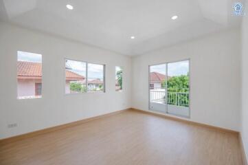 Empty room with wooden flooring and large windows