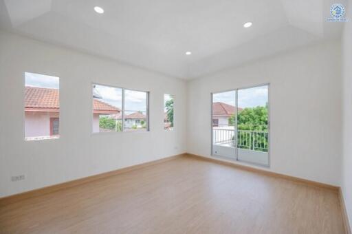 Empty room with wooden flooring and large windows