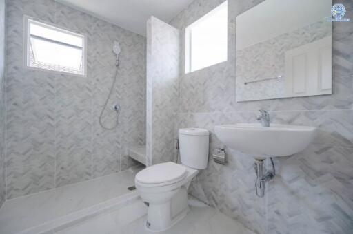 Modern bathroom with shower, toilet, and sink