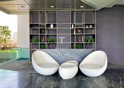 Modern lobby area with contemporary seating and artistic shelving