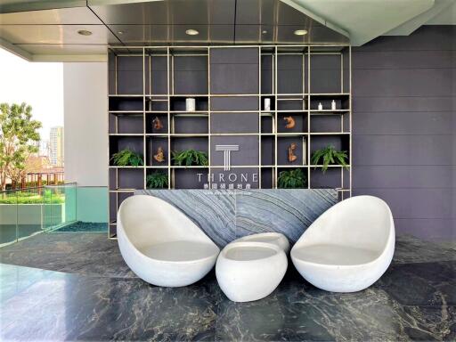 Modern lobby area with contemporary seating and artistic shelving