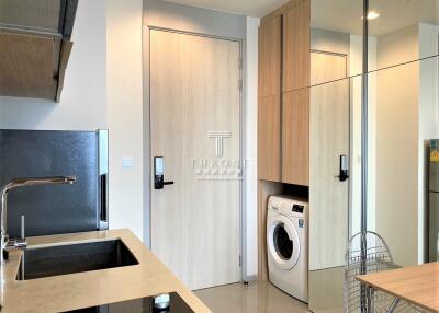 Modern kitchen with integrated appliances and a washing machine