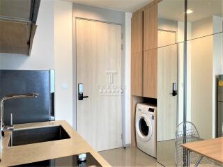 Modern kitchen with integrated appliances and a washing machine