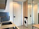 Modern kitchen with integrated appliances and a washing machine