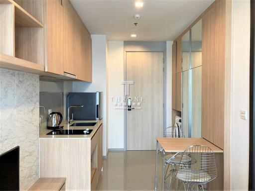 Modern kitchen with dining area and wooden cabinetry