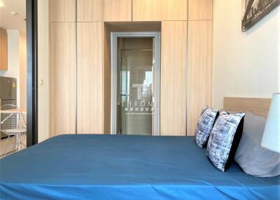Spacious bedroom with large built-in wardrobe and modern decor