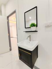 Modern bathroom with a vanity sink and a mirror.