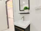 Modern bathroom with a vanity sink and a mirror.