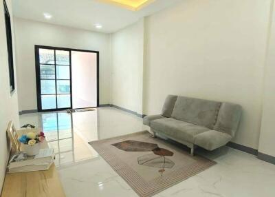 Modern living room with sleek furniture and elegant lighting.